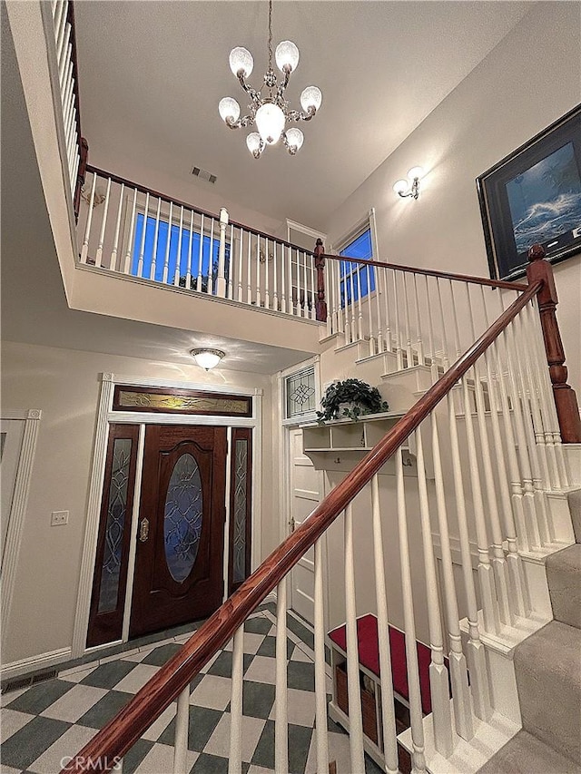 27601 Cedarwood Dr, Lake Arrowhead, CA 92352 - stairway featuring visible vents and a notable chandelier