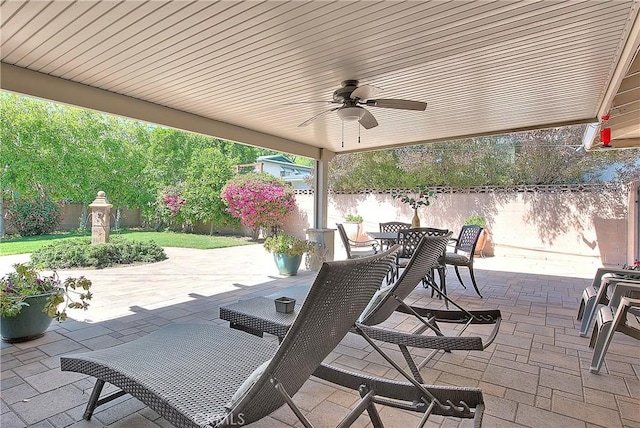 view of patio / terrace featuring a fenced backyard, outdoor dining space, and a ceiling fan