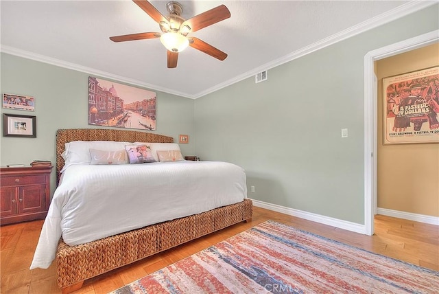 bedroom featuring visible vents, wood finished floors, and ornamental molding