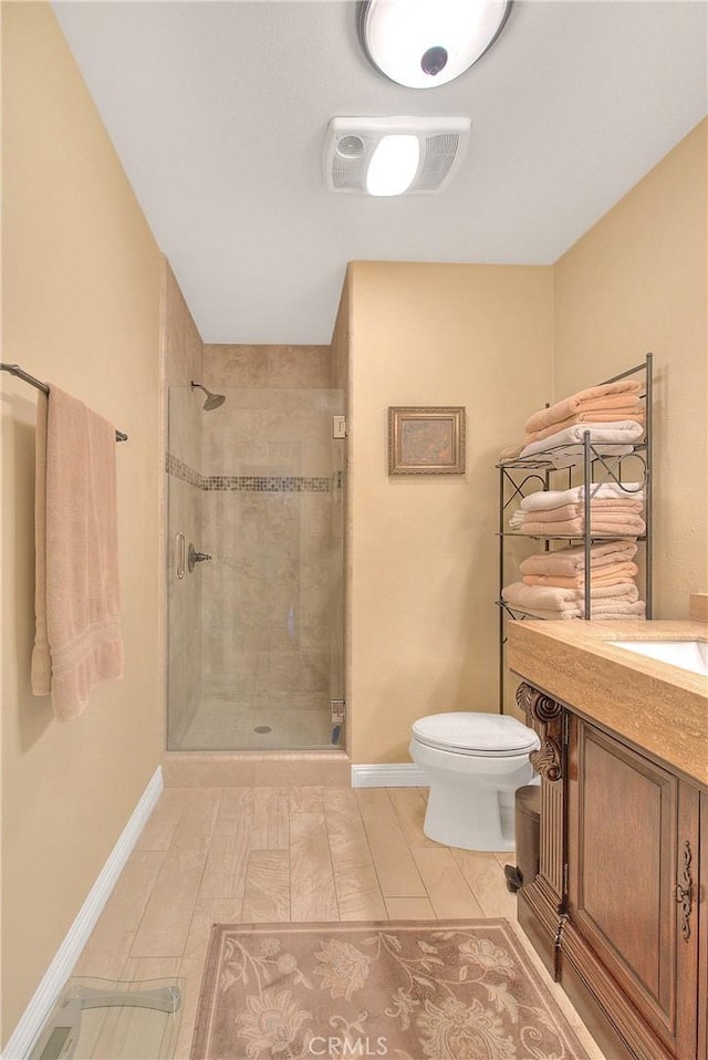 full bath with a stall shower, baseboards, visible vents, and toilet