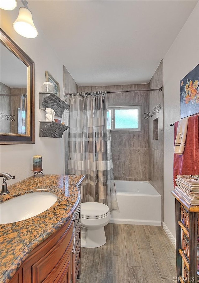 bathroom featuring shower / bath combination with curtain, toilet, vanity, and wood finished floors