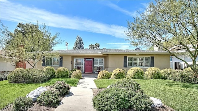 ranch-style house with stucco siding and a front lawn