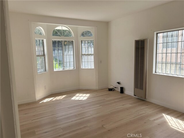 3391 Scarboro St, Los Angeles, CA 90065 - spare room with a heating unit, plenty of natural light, and light wood-style floors