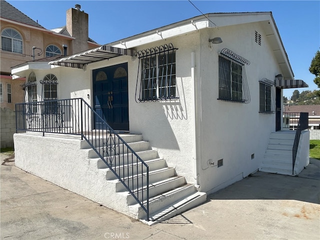 3391 Scarboro St, Los Angeles, CA 90065 - view of front of house with stucco siding and a chimney