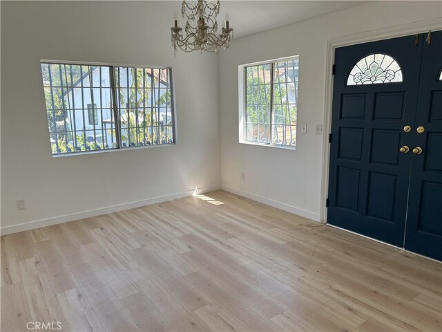 3391 Scarboro St, Los Angeles, CA 90065 - entrance foyer featuring a chandelier, wood finished floors, and baseboards