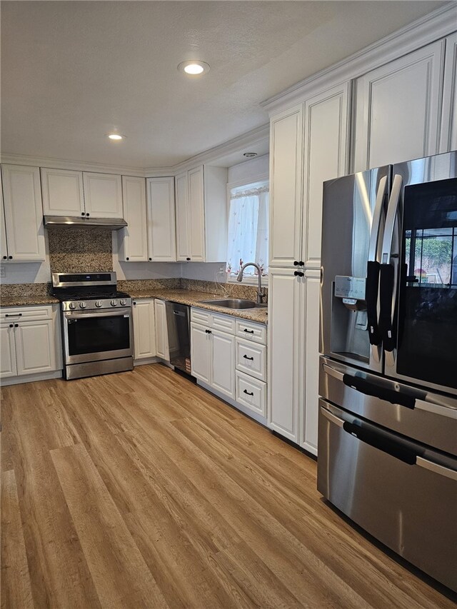 1043 W Orange Rd, Santa Ana, CA 92706 - kitchen featuring appliances with stainless steel finishes, a sink, light wood-style floors, white cabinets, and recessed lighting
