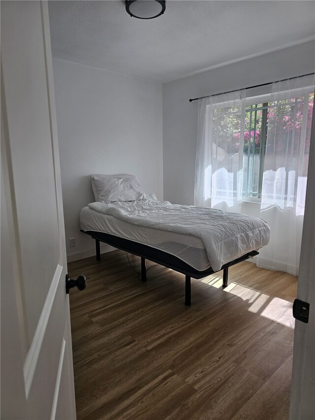 1043 W Orange Rd, Santa Ana, CA 92706 - bedroom featuring wood finished floors and baseboards