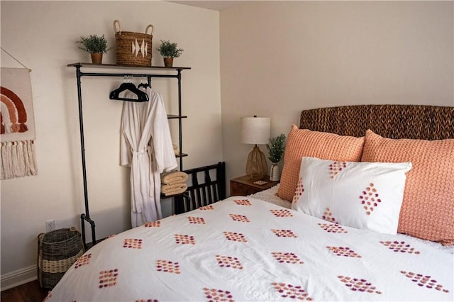 bedroom featuring wood finished floors and baseboards