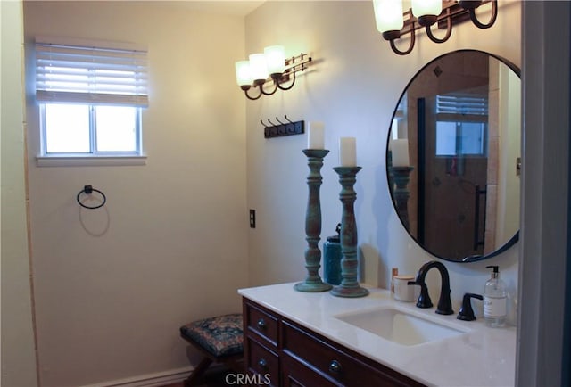 bathroom with a chandelier, vanity, and baseboards