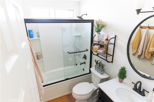 full bath with enclosed tub / shower combo, wood finished floors, toilet, and vanity