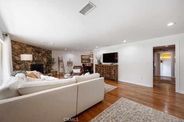 1040 Par Ave, Paso Robles, CA 93446 - living area with wood finished floors, recessed lighting, a stone fireplace, and baseboards