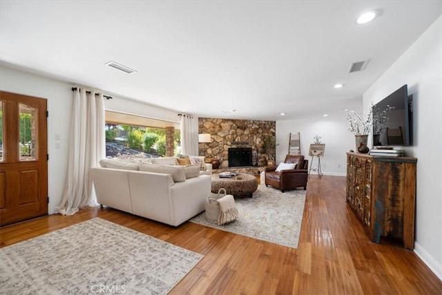 1040 Par Ave, Paso Robles, CA 93446 - living area featuring light wood-type flooring, a stone fireplace, baseboards, and recessed lighting