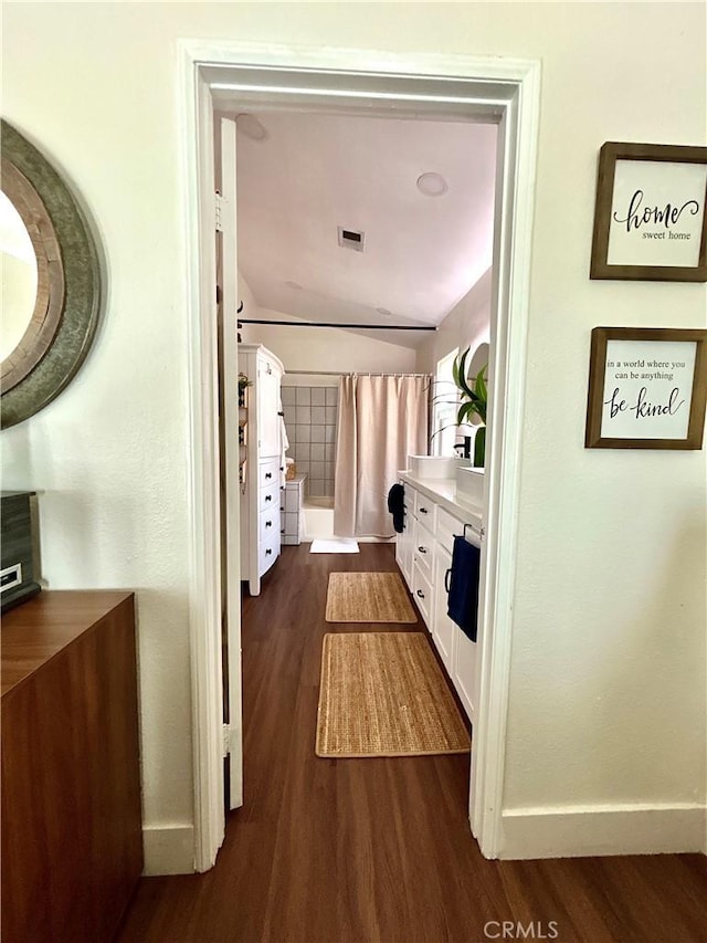 891 Hedges Dr, Corona, CA 92878 - hall with dark wood-style flooring, baseboards, and visible vents