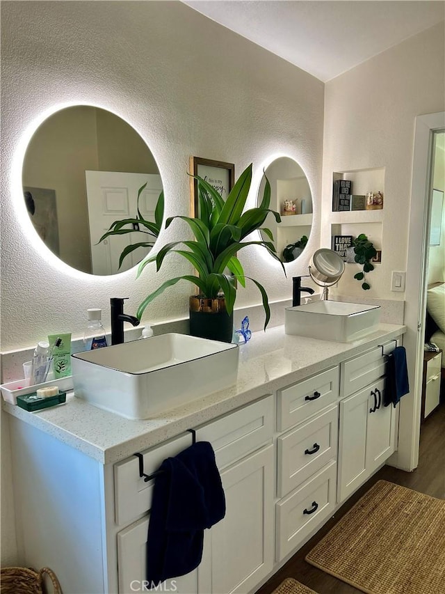 891 Hedges Dr, Corona, CA 92878 - full bath with a sink, a textured wall, double vanity, and wood finished floors