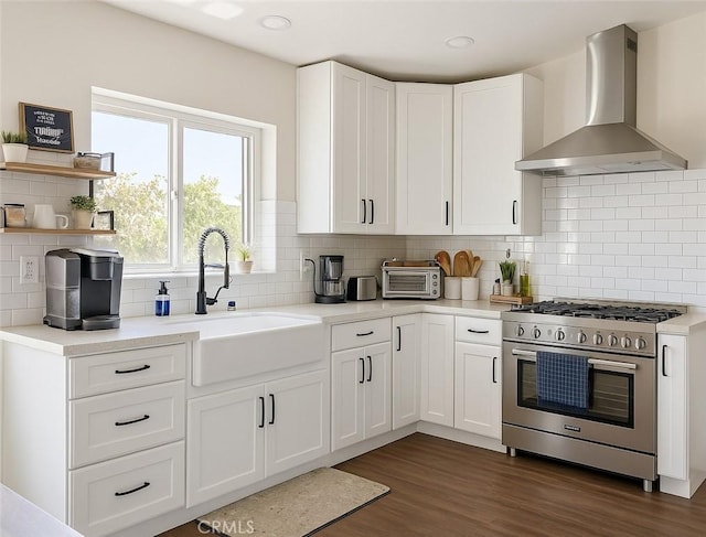 891 Hedges Dr, Corona, CA 92878 - kitchen with wall chimney exhaust hood, a sink, white cabinetry, backsplash, and high end stove