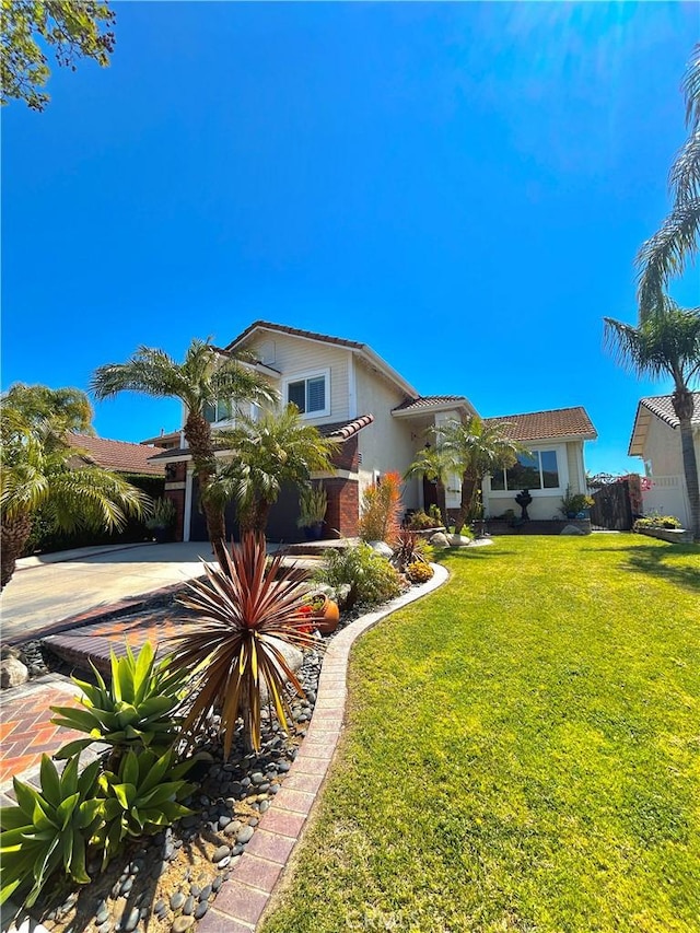 891 Hedges Dr, Corona, CA 92878 - mediterranean / spanish home featuring a front yard, a tiled roof, fence, and driveway