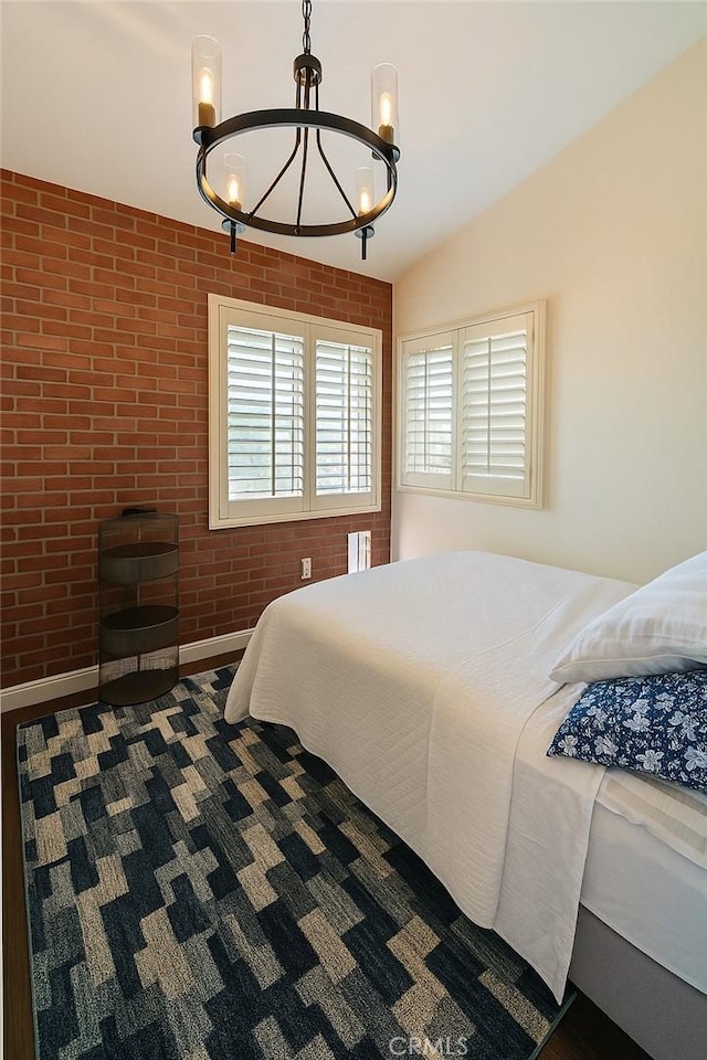 891 Hedges Dr, Corona, CA 92878 - bedroom with a chandelier and brick wall