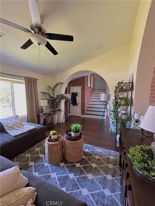 891 Hedges Dr, Corona, CA 92878 - living room with ceiling fan, stairway, arched walkways, and wood finished floors