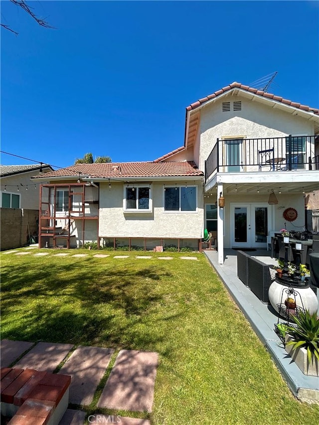 891 Hedges Dr, Corona, CA 92878 - back of house with a balcony, stucco siding, french doors, and a lawn