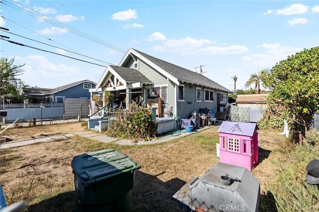 view of front of property with fence, a wooden deck, and a front yard