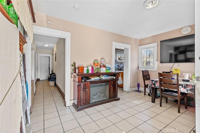 interior space with baseboards and light tile patterned floors