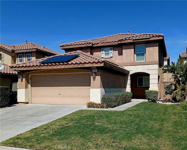 mediterranean / spanish-style house with stucco siding, a tile roof, a garage, and a front yard