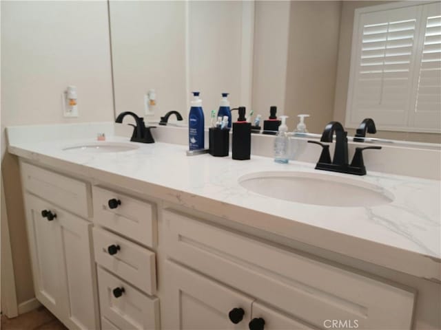 bathroom with double vanity and a sink
