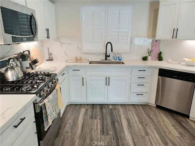 kitchen featuring white cabinets, a sink, and appliances with stainless steel finishes