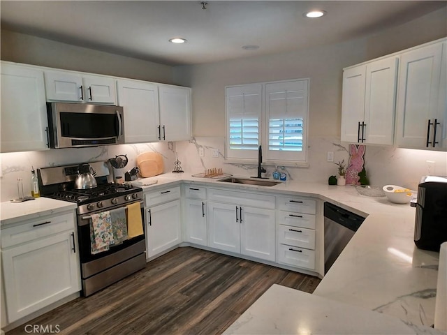 kitchen with white cabinets, a sink, and stainless steel appliances