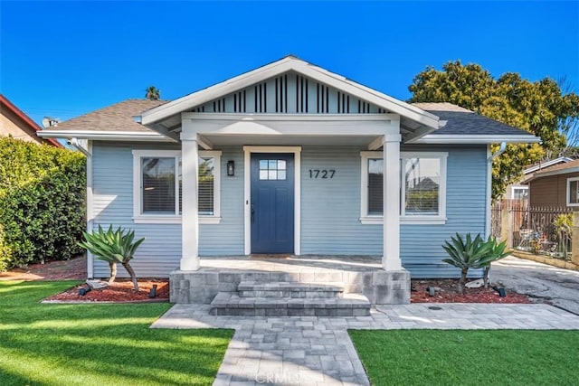 1727 W 59th Pl, Los Angeles, CA 90047 - bungalow with a porch and roof with shingles