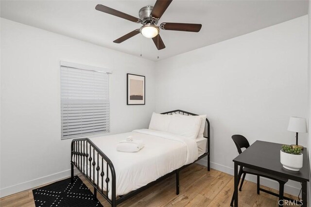 1727 W 59th Pl, Los Angeles, CA 90047 - bedroom featuring light wood-style flooring, a ceiling fan, and an office area