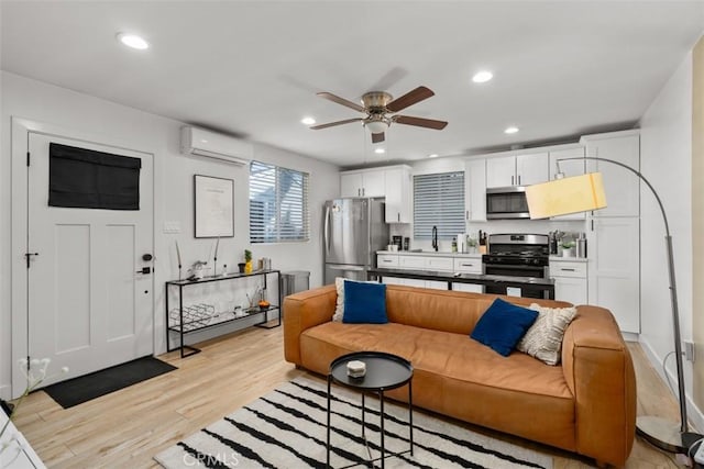 1727 W 59th Pl, Los Angeles, CA 90047 - living room featuring a wall mounted air conditioner, light wood finished floors, a ceiling fan, and recessed lighting