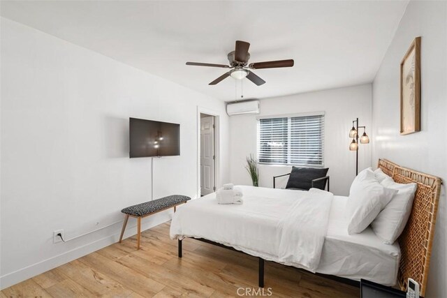 1727 W 59th Pl, Los Angeles, CA 90047 - bedroom with an AC wall unit, wood finished floors, and a ceiling fan