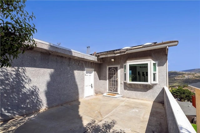 exterior space with a patio area and stucco siding