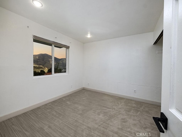 empty room featuring baseboards, recessed lighting, and carpet flooring