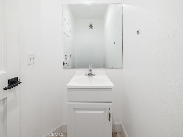 bathroom with baseboards and vanity