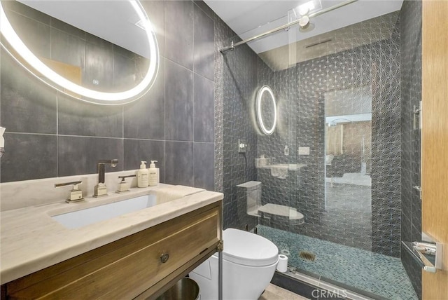 14084 Bronte Dr, Whittier, CA 90602 - bathroom featuring vanity, tile walls, toilet, backsplash, and a stall shower