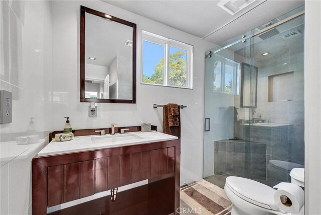 14084 Bronte Dr, Whittier, CA 90602 - bathroom featuring a shower stall, visible vents, toilet, and vanity