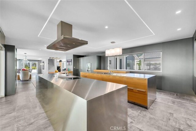 14084 Bronte Dr, Whittier, CA 90602 - kitchen featuring black electric cooktop, island exhaust hood, modern cabinets, a sink, and a spacious island