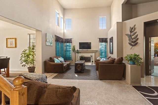 19189 San Jacinto Way, Apple Valley, CA 92308 - carpeted living room featuring a glass covered fireplace and a towering ceiling