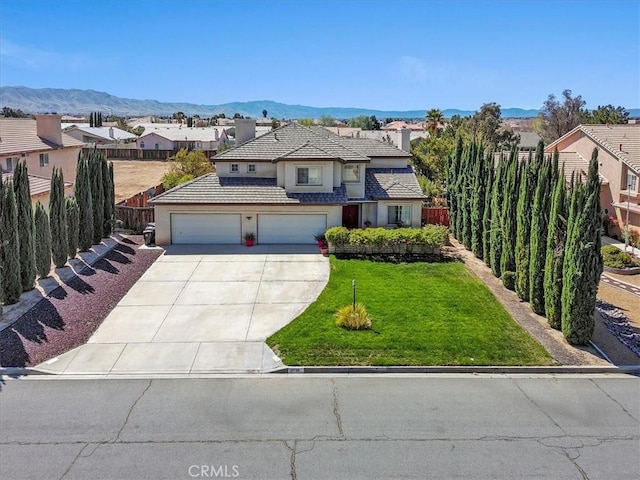 19189 San Jacinto Way, Apple Valley, CA 92308 - view of front facade with driveway, a front yard, fence, and stucco siding