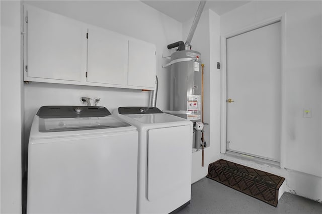 clothes washing area with cabinet space, washer and dryer, and water heater