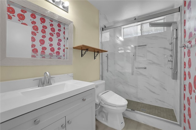 bathroom with toilet, a marble finish shower, and vanity