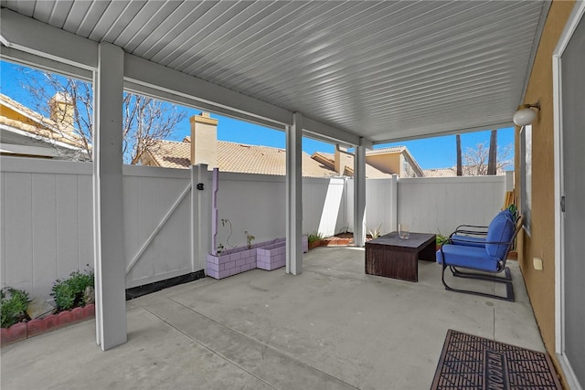 view of patio / terrace featuring a fenced backyard and a gate