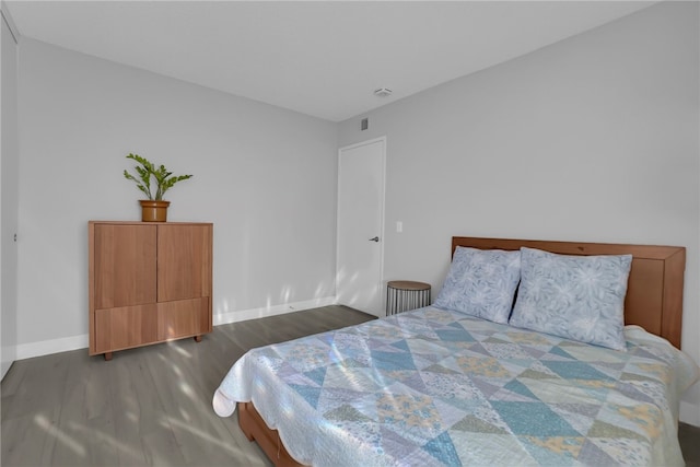 bedroom featuring wood finished floors and baseboards
