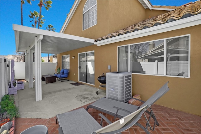 view of patio featuring fence and cooling unit