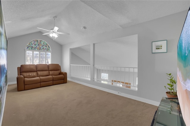 living area featuring ceiling fan, carpet, vaulted ceiling, and baseboards