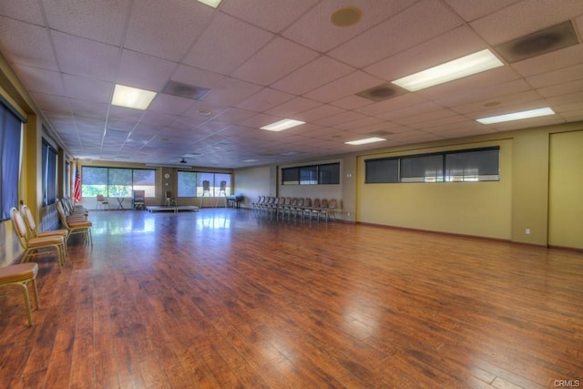 empty room with a paneled ceiling and wood finished floors