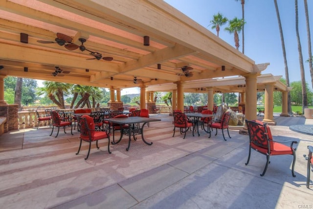 view of patio with outdoor dining space and a ceiling fan