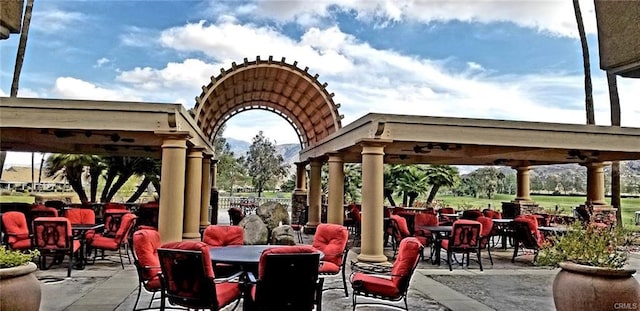 view of patio featuring a mountain view, a gazebo, and outdoor dining area